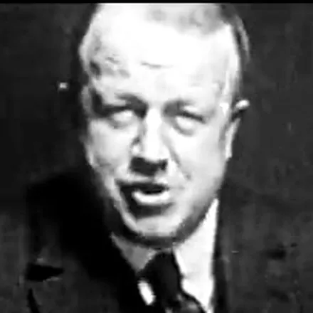 Frank Gilbreth, head and
                    shoulders, mid-sentence — a frame from his own film.